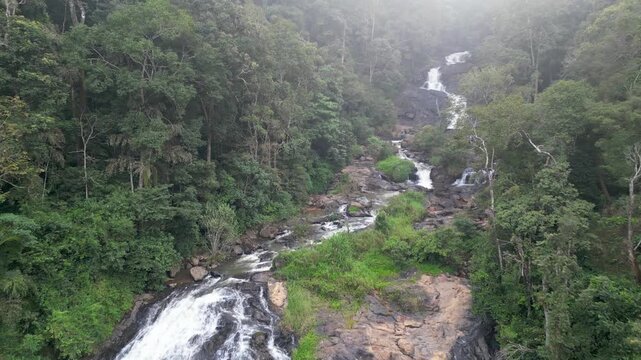 Scenic Abbey waterfalls in tropical landscape in Coorg district, Karnataka, India covered with fog.