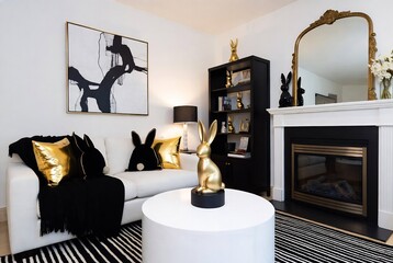 Naklejka premium A luxurious living room with a black and white color scheme, featuring rabbit decor and a fireplace.
