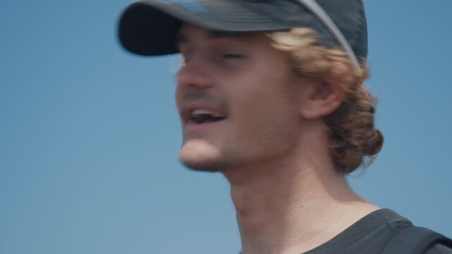 Portrait of the young man talking during outdoor interview