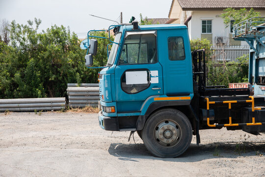 Blue lorry cabin with blank space on the door for logo mockup, parked outdoors.