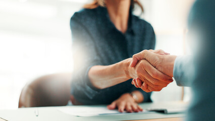 Handshake, deal and business people in office with partnership, contract or finance agreement. Meeting, welcome and financial advisor shaking hands with investor for investment negotiation at agency. © peopleimages.com