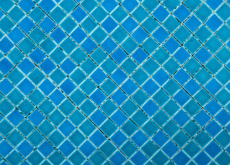 Blue mosaic tile pattern background. Geometric ceramic tiles surface with turquoise and blue tones forming decorative texture