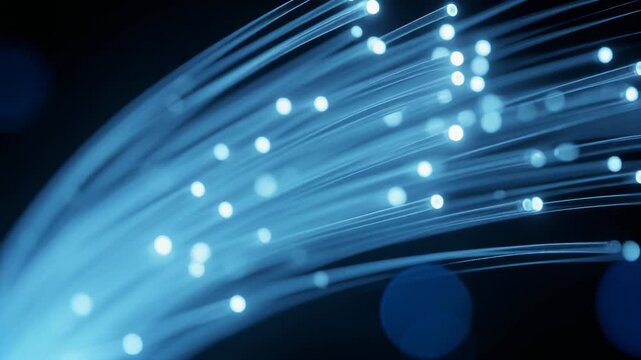 Close up of glowing blue fiber optic cables transmitting light data technology background