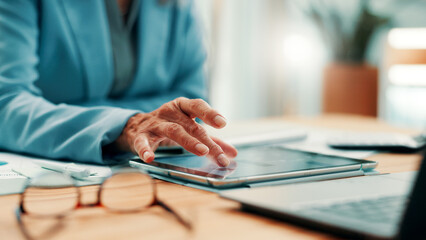 Fototapeta premium Business, tablet and hands of woman at desk for research, investment and online website for report. Corporate, mature and person on digital tech for financial review, budget planning and proposal