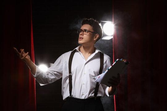 Male screenwriter with scenario on scene