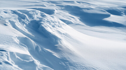 Soft snow drifts shaping winter landscape with flowing textures and contrasting blue shadows