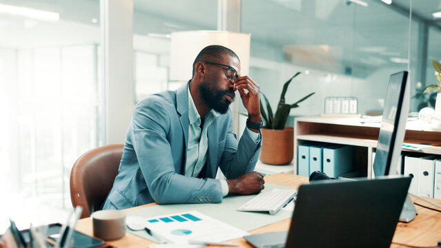Stress, headache and black man in office with fatigue, mistake or brain fog for finance report. Glasses, exhaustion and African male financial advisor with migraine for error in investment proposal