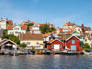 Obraz premium Waterfront houses, boathouses and boats at Fiskebäckskil on Skaftö island, Bohuslän, Sweden