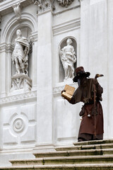Venice, Italy - February 13, 2026 - People dressed in masks for the Venice Carnival have their photos taken by tourists