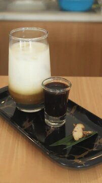 Close Up Iced Milk Coffee With Palm Sugar And Fresh Ginger Garnish