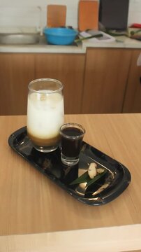 Traditional Iced Coffee With Palm Sugar And Ginger On Wooden Table