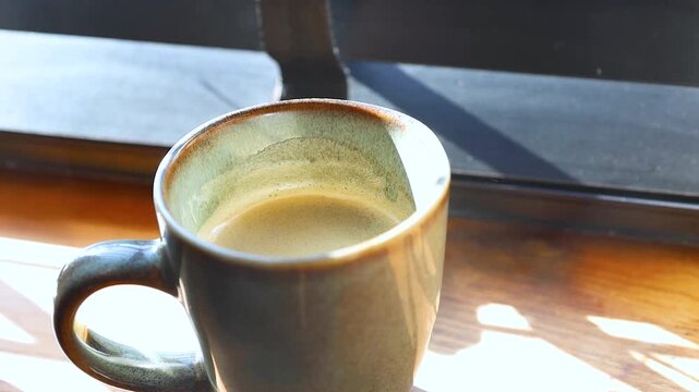Video of cup of coffee on a table.
