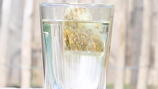 Close up shot of teabag inside teaglass.