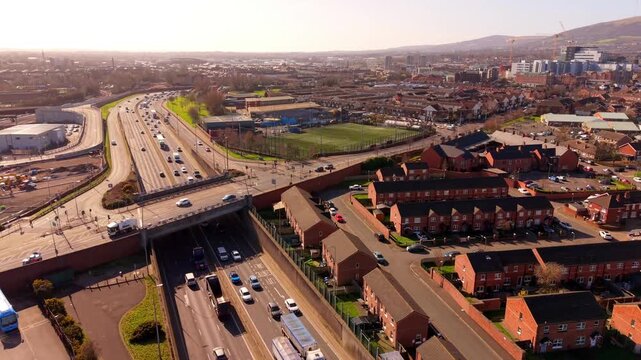 Reversing aerial video GV of the M1 Motorway and West Belfast in Belfast, Northern Ireland in the UK. Produced in 4K, 60FPS with Rec709 color.