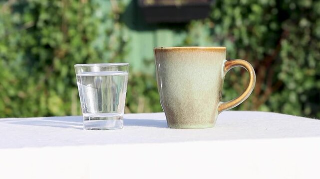 Shot of milk pouring into a cup of coffee.