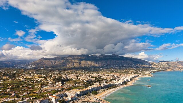 Altea coastline with church, beach and mountains under dramatic clouds, Costa Blanca, Alicante, Spain