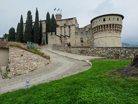 Winding Cobblestone Road Leading To Main Castle Entrance With Round Tower , Brescia, Italy