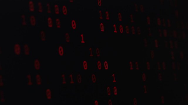 Red binary code on a black background on the computer screen. concept of dangers of cybersecurity, data security, and computer virus attacks in digital age.