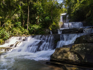 Obraz premium Epic Aerial View of Nangga Tiered Waterfall in Tropical Forest, Central Java Indonesia. Long Exposure Drone Shot 
