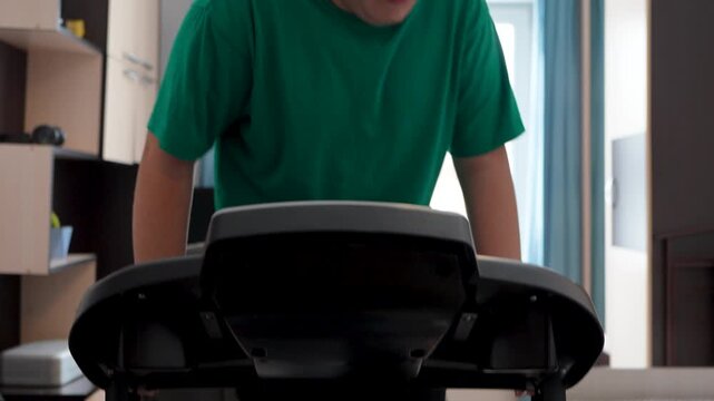 A teenager running on a treadmill at home, focusing on weight loss, health improvement, and managing obesity.