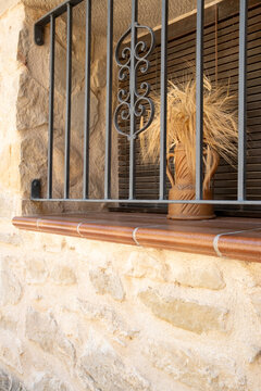 Iron grille on stone window facade with texture detail in Valderrobres Aragon Spain captured in daylight highlighting traditional craftsmanship