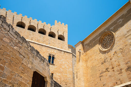 Stone church facade with window medieval architecture in Valderrobres Aragon Spain in clear daylight highlighting historic character and texture