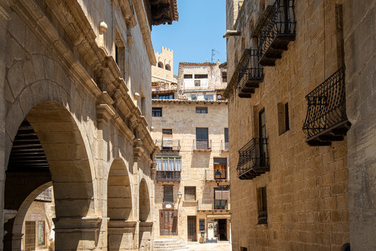 Quiet stone alley with archway medieval architecture and shadow in Valderrobres Aragon Spain seen in daylight with strong texture and depth
