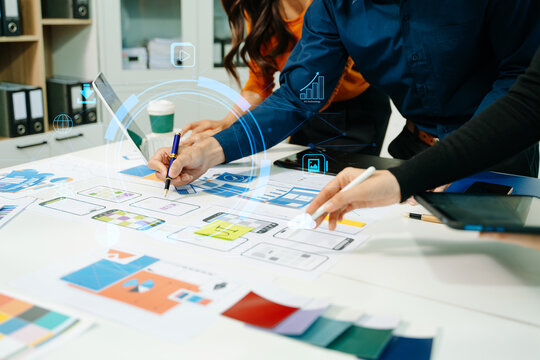 Innovative team planning UI UX mobile app interface with digital technology overlay, collaborating on data analytics, product design