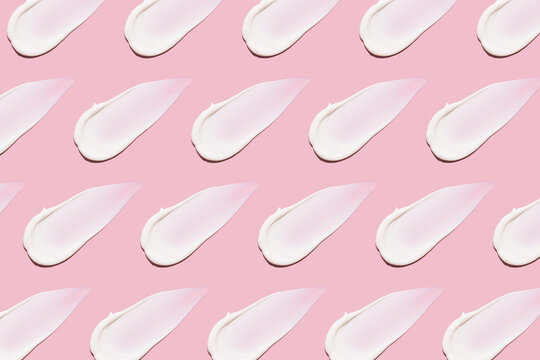 Beauty cream swatch pattern on pink background with copy space