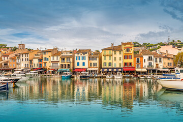 Scenic view of the village of Cassis in south of France against dramatic storm sky with reflection to Mediterranean sea 
