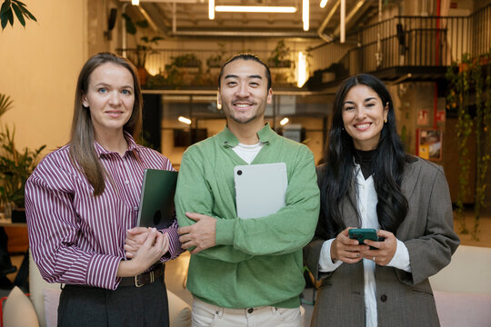 Confident business team smiling in modern office setting