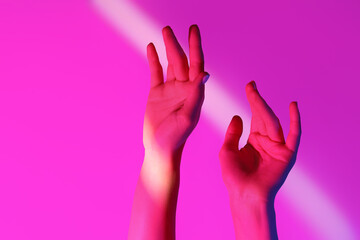 Obraz premium Toned female hands on pink background