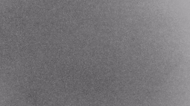 Abstract Gray Noise Static Background with Grainy Texture and Fading Light.