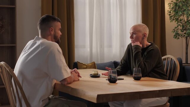 Couple having intimate conversation at home dinner table