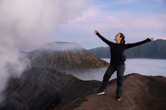 Traveler exploring volcano crater at sunrise in Java Indonesia