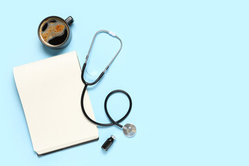 Blank clipboard with stethoscope and cup of coffee on blue background. World Health Day