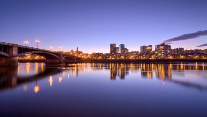 Naklejka premium Cityscape at Dusk with Bridge and Reflections