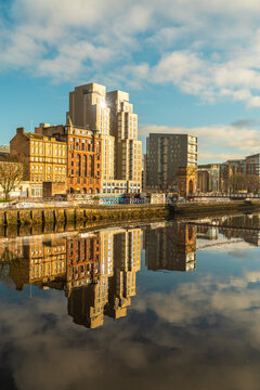 Glasgow cityscape and historic riverside architecture reflected on sunny autumn day
