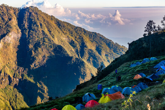 Colorful tents at Sembalun crater rim campsite on Mount Rinjani, Lombok, Indonesia.