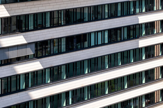 Abstract modern architecture building facade with windows and horizontal lines creating urban pattern in minimal design with strong geometric perspective