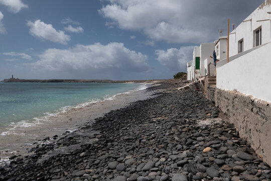 Volcanic stone coast and seaside houses Puertito de la Cruz Fuerteventura Canary Islands Spain Atlantic Ocean
