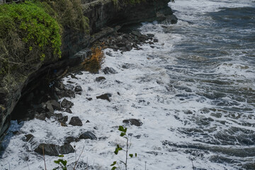 Fototapeta premium Powerful White Ocean Waves Crashing Against Rocky Shore, Dramatic Coastal Seascape