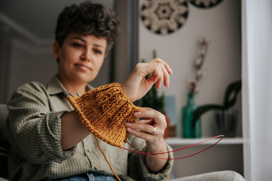 Knitting handmade wool project at home in cozy interior