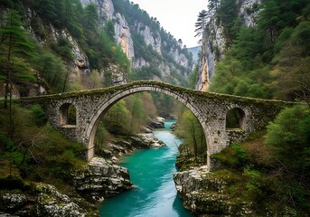 Fototapeta premium Ancient stone bridge spanning a serene river in a lush, mountainous landscape