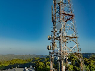 A telecommunications tower stands tall against a clear blue sky in Auckland, New Zealand. The tower is equipped with various antennas and dishes, facilitating communication across the region. © Stefan