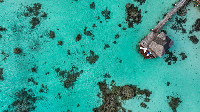 Aerial view of a sundeck over turquoise lagoon in Fakarava French Polynesia