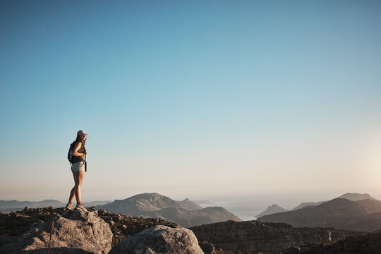 Hiking, mountain and vision with woman in nature for adventure, blue sky space or travel holiday. Explore, tourism vacation and trekking with person on rock hill for journey, backpacking and thinking