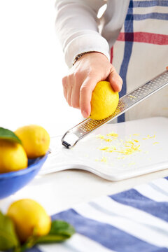 woman hands grating lemon zest