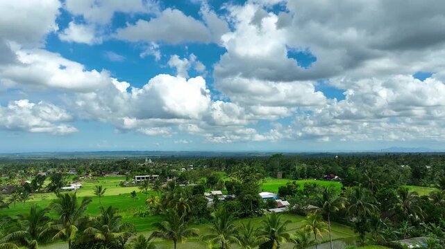 Drone panning to the right above Indonesian village, Sasak overview in midday sun