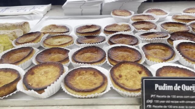 Variety of Portuguese pasties and queijada at Time Out Market in Lisbon, Portugal